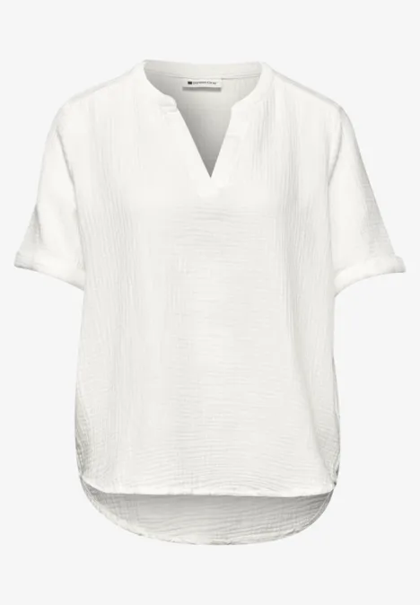 Weißes, locker geschnittenes Damenblusenshirt mit kurzen Ärmeln und V-Ausschnitt.